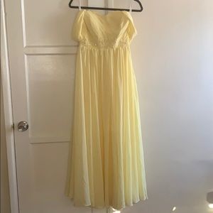 A beautiful, yellow dress that drapes gracefully.